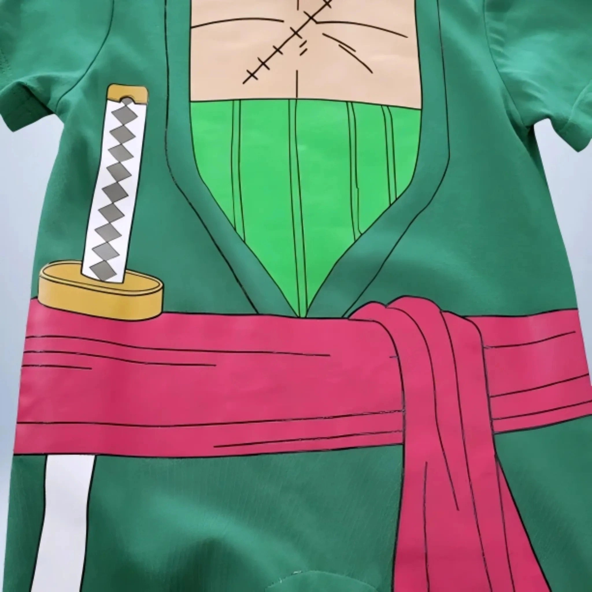 Détail du torse du body Zoro pour bébé avec cicatrice et kimono vert
